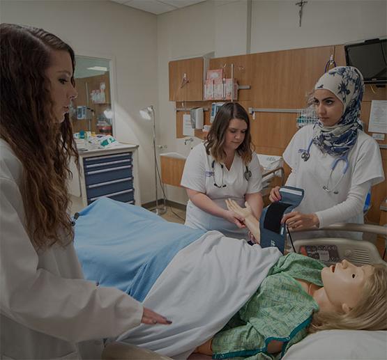 Two Students Gaining Experience in Nursing Simulation Lab